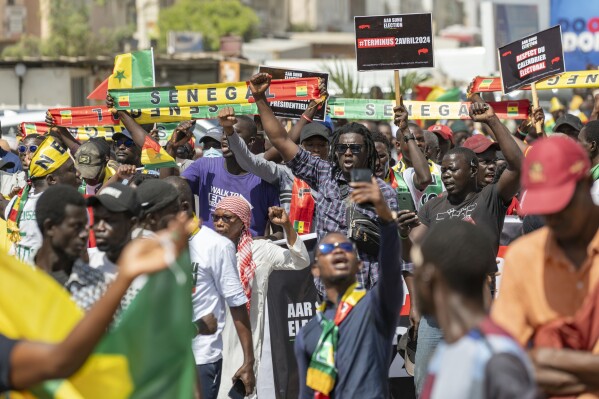 Supporters of the Aar Sunu Senegal opposition collective demonstrate on a street, in Dakar, Saturday, Feb. 17, 2024. Senegal's government says it will hold a presidential election as soon as possible given that the country's top election authority has overturned a decree by President Macky Sall to postpone the vote. (AP Photo/Sylvain Cherkaoui)
