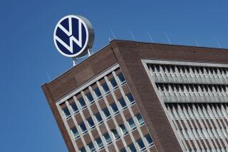 FILE - The Volkswagen logo stand on the top of a VW headquarters building in Wolfsburg, Germany, Monday, April 27, 2020. Volkswagen profits fell 30% in the first three months of the year despite booming business in Europe and North America because sales dropped in China, where the German automaker is facing increasing competition from homegrown models. (Swen Pfoertner/dpa via AP, File)