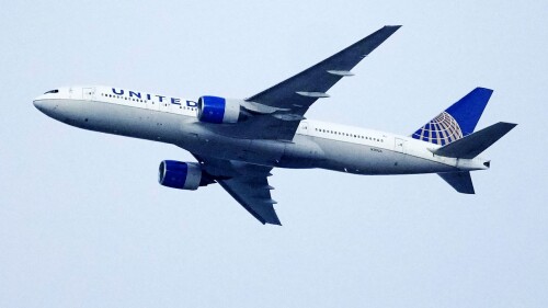 FILE - A United Airlines jetliner soars past an MLS soccer match July 8, 2023, in Commerce City, Colo. United Airlines and the union representing its pilots said Saturday, July 15, 2023, they reached agreement on a contract that will raise pilot pay by up to 40% over four years. (AP Photo/David Zalubowski, File)