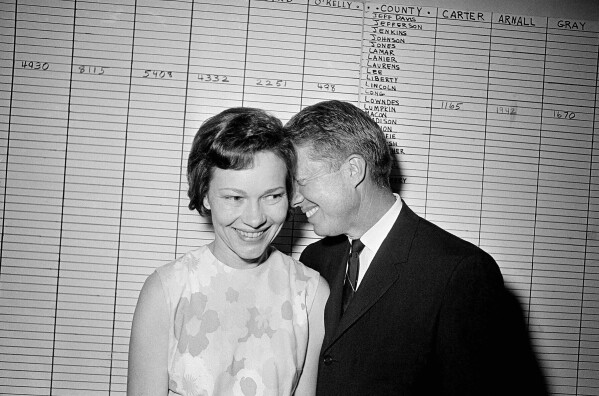 Georgia State Sen. Jimmy Carter hugs his wife, Rosalynn, at his Atlanta campaign headquarters on Sept. 15, 1966. (AP Photo, File)