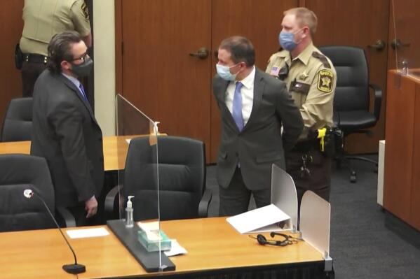 FILE - Former Minneapolis Police Officer Derek Chauvin, center, is taken into custody as his attorney, Eric Nelson, left, looks on after the verdicts were read at Chauvin's trial for the 2020 death of George Floyd, at the Hennepin County Courthouse in Minneapolis, April 20, 2021. The third anniversary of Floyd’s murder is Thursday, May 25, 2023. (Court TV via AP, Pool, File)