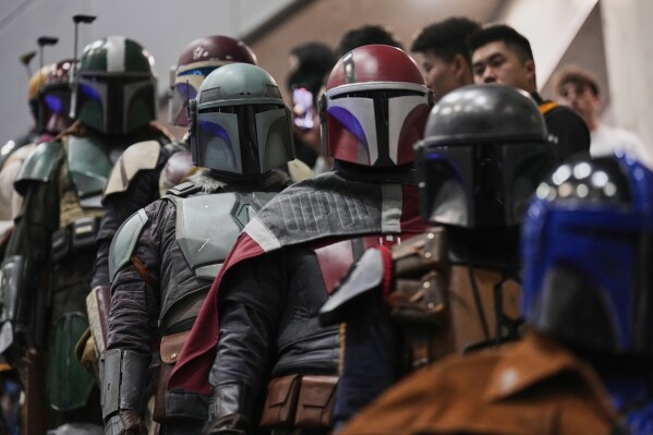 Star Wars fans in different creations of the Boba Fett uniforms attend a fan convention called the Star Wars Celebration in Chiba, near Tokyo, Friday, April 18, 2025. (AP Photo/Hiro Komae)