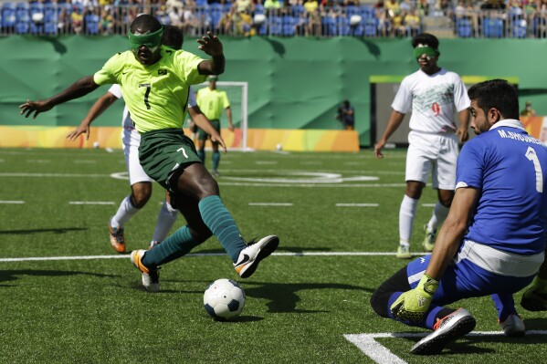 FILE - Brazil's Jefinho, left, kicks the ball as Iran' goalkeeper Meysam Shojaeiyan blocks, during a men's group A preliminary soccer 5-a-side match, at the Paralympic Games event in Rio de Janeiro, Brazil, Tuesday, Sept. 13, 2016. (AP Photo/Leo Correa, File)