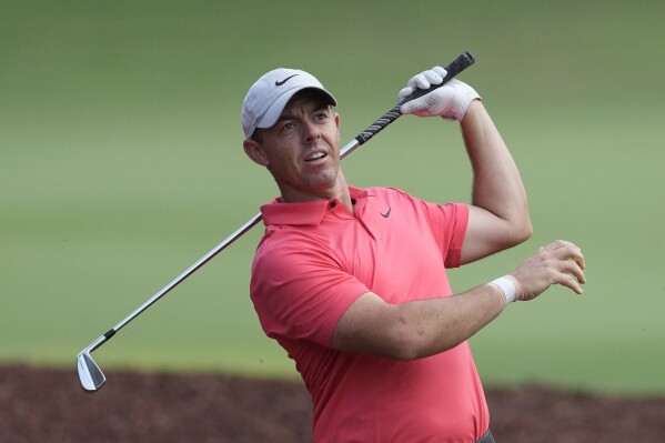 Rory McIlroy of Northern Ireland plays his second shot on the 18th hole during the round one of the DP World Tour Championship golf tournament, in Dubai, United Arab Emirates, Thursday, Nov. 16, 2023. (AP Photo/Kamran Jebreili)