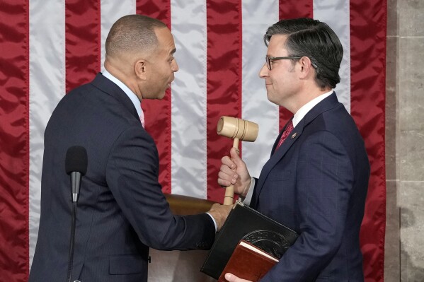 FILE - House Minority Leader Hakeem Jeffries of N.Y., hands the gavel to speaker-elect Rep. Mike Johnson, R-La., at the Capitol in Washington, Oct. 25, 2023. (Ǻ Photo/Alex Brandon, File)