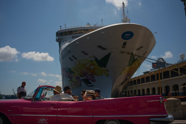 Tourists who have just disembarked from a cruise liner, tour the city aboard a vintage American convertible, in Havana, Cuba, Tuesday, June 4, 2019. The Trump administration has imposed major new travel restrictions on visits to Cuba by U.S. citizens, banning stops by cruise ships and ending a heavily used form of educational travel as it seeks to further isolate the communist government. (AP Photo/Ramon Espinosa)