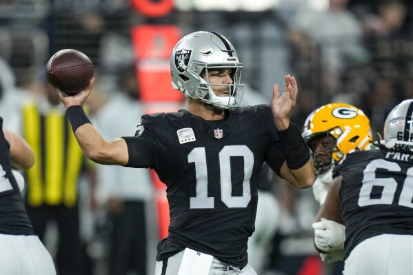Las Vegas Raiders' Jimmy Garoppolo throws a pass during the first half of an NFL football game against the Green Bay Packers Monday, Oct. 9, 2023, in Las Vegas. (AP Photo/John Locher)