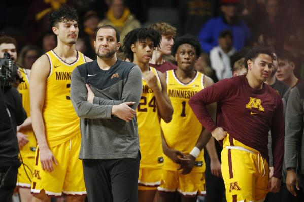 Minnesota coach Ben Johnson and the team await the official review to see if a 3-pointer against Rutgers at the buzzer would stand in the NCAA college basketball game Thursday, March 2, 2023, in Minneapolis. Minnesota won 75-74. (AP Photo/Bruce Kluckhohn)