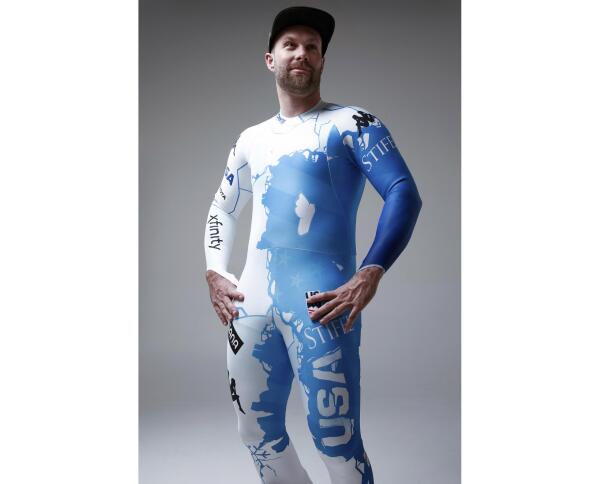 In this undated photo provided by Kappa U.S. ski racer Travis Ganong wears the new race suit to be worn at the world ski championships in France. U.S. Ski & Snowboard, in collaboration with Kappa and Protect Our Winters, designed the suit to help elevate climate change as a priority in snow sports. (Kappa via AP)