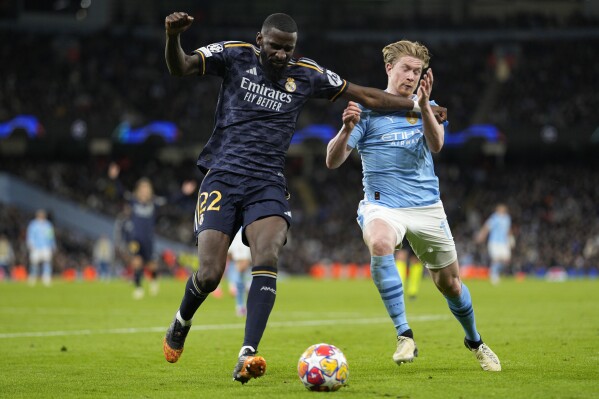 Manchester City's Kevin De Bruyne, right, fights for the ball with Real Madrid's Antonio Rudiger during the Champions League quarterfinal second leg soccer match between Manchester City and Real Madrid at the Etihad Stadium in Manchester, England, Wednesday, April 17, 2024. (AP Photo/Dave Shopland)