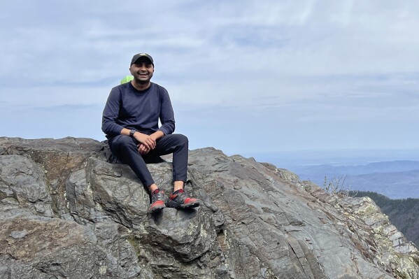 Prince Bhojwani sits on Charlies Bunion mountain along the Appalachian Trail in Great Smoky Mountains National Park in Tennessee on April 17, 2022. (Nita Bhojwani via AP)