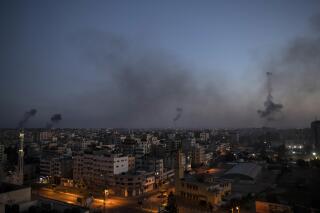 Black smoke rise following Israeli airstrikes on Gaza City, Wednesday, May 12, 2021. (AP Photo/Khalil Hamra)