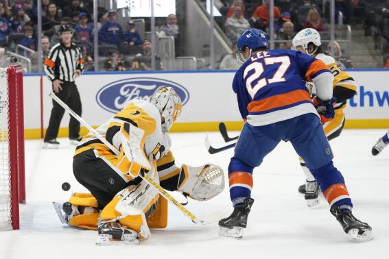 New York Islanders left wing Anders Lee (27) scores a goal past Pittsburgh Penguins goaltender Casey DeSmith (1) during the second period of an NHL hockey game, Friday, Feb. 17, 2023, in Elmont, N.Y. (AP Photo/Mary Altaffer)