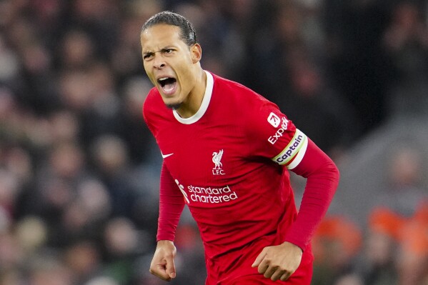 Liverpool's Virgil van Dijk celebrates after scoring his side's first goal during the English Premier League soccer match between Liverpool and Luton Town, at Anfield stadium in Liverpool, England, Wednesday, Feb. 21, 2024. (APPhoto/Jon Super)