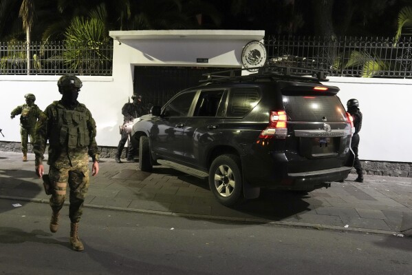 Police try to break into the Mexican embassy in Quito, Ecuador, Friday, April 5, 2024, after Mexico granted asylum to former Ecuadorian Vice President Jorge Glass, who sought asylum there.  Later, the police forcefully entered the embassy through another entrance.  (AP Photo/Dolores Ochoa)