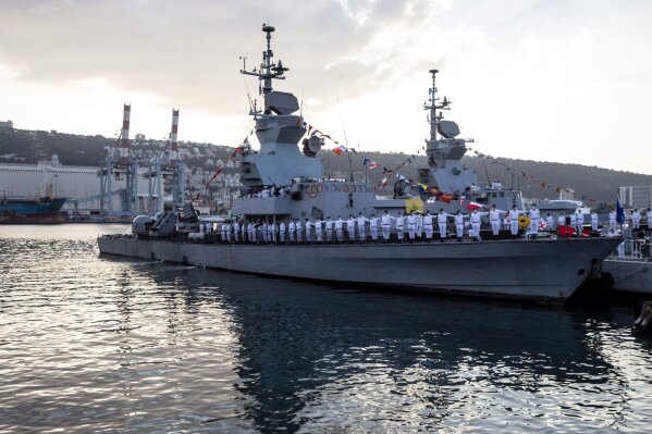 Israeli sailors stand on a Sa'ar 4.5 ship during a ceremony marking the arrival of first of four new Sa'ar 6 ships in Haifa, Israel on Wednesday, Dec. 2, 2020. Israel’s Navy on Wednesday welcomed the first of four German-made warships that will be at the vanguard of the country’s efforts to protect its coastline and growing natural-gas industry. The first missile boat of “Project Magen” docked at Israel’s Haifa port, with three more of the German-made corvettes scheduled to arrive over the next two years. (Heidi Levine/Pool Photo via AP)