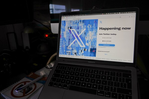 A view of a laptop shows an X sign-in page and logo, in Belgrade, Serbia, July 24, 2023. (AP Photo/Darko Vojinovic, File)