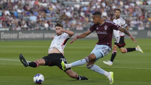 Colorado Rapids forward Calvin Harris, right, kicks the ball past FC Dallas defender Amet Korca during the first half of an MLS soccer match Saturday, July 8, 2023, in Commerce City, Colo. (AP Photo/David Zalubowski)