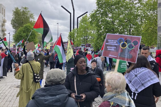 Demonstrators demanding the boycott of Israel during Olympic Games demonstrate outside the Paris Olympic organizing committee headquarters, Tuesday, April 30, 2024 in Saint-Denis, outside Paris. About 300 pro-Palestinian demonstrators took part on the protest. (AP Photo/Alexander Turnbull)