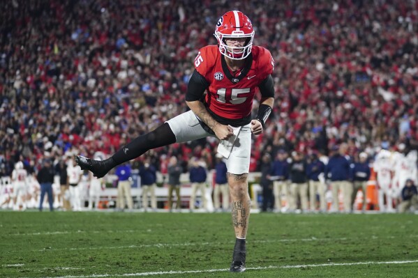 Georgia quarterback Carson Beck (15) reacts after a Georgia touchdown during the first half of an NCAA college football game against Mississippi, Saturday, Nov. 11, 2023, in Athens, Ga. (AP Photo/John Bazemore)
