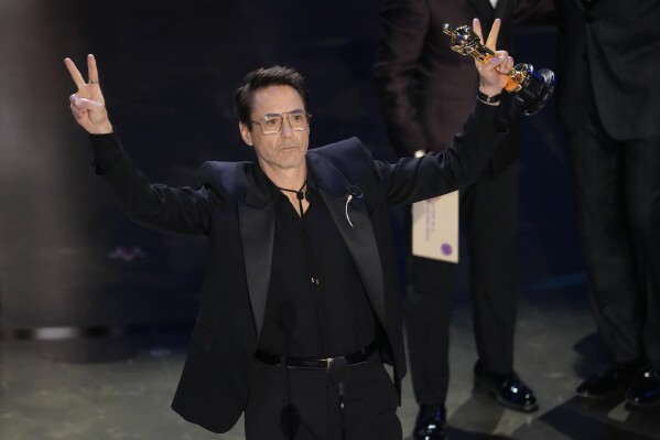 Robert Downey Jr. accepts the award for best performance by an actor in a supporting role for 