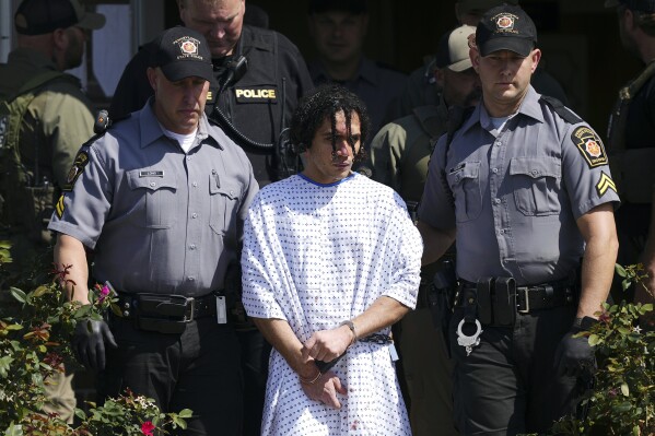 FILE - Law enforcement officers escort Danilo Cavalcante from a Pennsylvania State Police barracks in Avondale Pa., Wednesday, Sept. 13, 2023. Cavalcante, a convicted murderer who escaped from a southeastern Pennsylvania prison earlier this year and eluded a massive two-week search before he was recaptured, was arraigned Friday, Feb. 2, 2024, on theft, burglary and other charges in connection with alleged crimes committed while he was on the run. (AP Photo/Matt Rourke, FIle)
