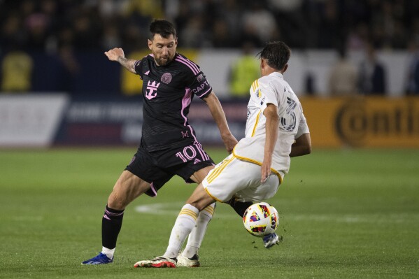 Inter Miami forward Lionel Messi (10) dribbles the ball away from Los Angeles Galaxy defender Juli谩n Aude (3) during the second half of an MLS soccer match, Sunday, Feb. 25, 2024, in Carson, Calif. (AP Photo/Kyusung Gong)