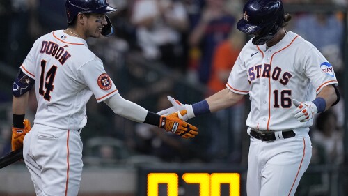 Houston Astros' Grae Kessinger (16) is congratulated by Mauricio Dubon (14) after hitting a solo home run during the third inning of a baseball game against the Colorado Rockies, Tuesday, July 4, 2023, in Houston. (AP Photo/Kevin M. Cox)