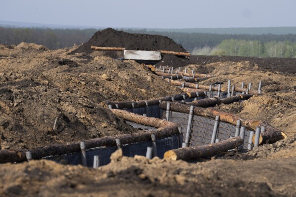 A newly constructed defensive position is seen in the field close to the Russian border in the Kharkiv region, Ukraine, on Wednesday, April 17, 2024. (AP Photo/Evgeniy Maloletka)