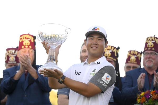 Tom Kim, of South Korea, displays the trophy after winning the Shriners Children's Open golf tournament, Sunday, Oct. 9, 2022, in Las Vegas. (AP Photo/David Becker)