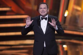 FILE - Norm Macdonald hosts the Canadian Screen Awards in Toronto on March 13, 2016. Macdonald, a comedian and former cast member on "Saturday Night Live," died Tuesday, Sept. 14, 2021, after a nine-year battle with cancer that he kept private, according to Brillstein Entertainment Partners, his management firm in Los Angeles. He was 61. (Peter Power/The Canadian Press via AP, File)