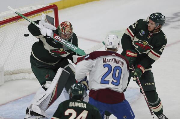 Colorado Avalanche center Nathan MacKinnon (29) scores a goal against Minnesota Wild goaltender Filip Gustavsson, left, during the third period of an NHL hockey game Monday, Oct. 17, 2022, in St. Paul, Minn. (AP Photo/Stacy Bengs)