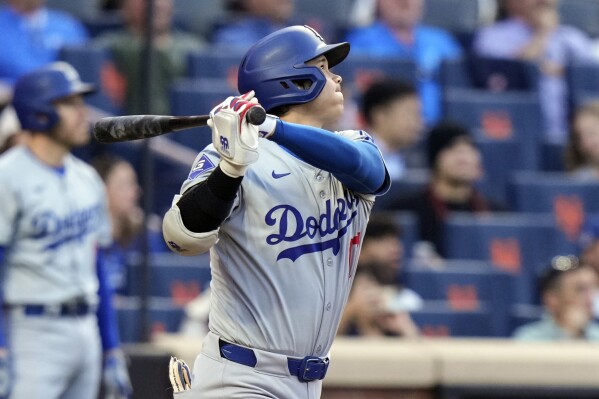 Los Angeles Dodgers' Shohei Ohtani, of Japan, follows through on a two-run home run during the eighth inning of a baseball game against the New York Mets, Wednesday, May 29, 2024, in New York. (AP Photo/Frank Franklin II)