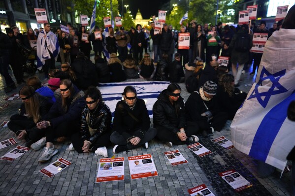 FILE - People portraying as the hostages kidnapped during the Oct. 7 Hamas bloody cross-border attack takes part in a vigil in Prague, Czech Republic, Tuesday, Nov. 7, 2023. (AP Photo/Petr David Josek, File)