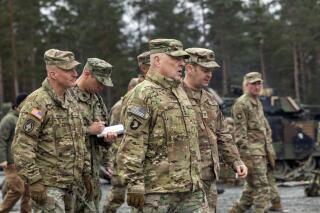 In this image provided by the U.S. Army, U.S. Chairman of the Joint Chiefs of Staff Gen. Mark Milley meets with U.S. Army leaders responsible for the collective training of Ukrainians at Grafenwoehr Training Area, Grafenwoehr, Germany, on Monday, Jan. 16, 2023. At left is Brig. Gen. Joseph E. Hilbert, who is the commanding general for the 7th Army Training Command. Milley visited the training site in Germany for Ukrainian forces and met with troops and commanders.(Staff Sgt. Jordan Sivayavirojna/U.S. Army via AP)