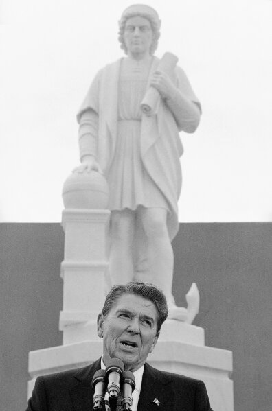 FILE - In this Monday, Oct. 9, 1984, file photo, President Ronald Reagan addresses a ceremony in Baltimore, to unveil a statue of Christopher Columbus. Baltimore protesters pulled down the statue of Christopher Columbus and threw it into the city's Inner Harbor, Saturday, July 4, 2020. (AP Photo/Lana Harris, File)