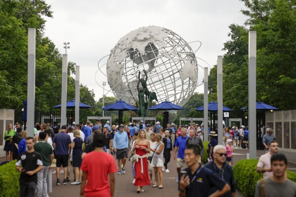 Tennis fans arrive at the Billie Jean King National Tennis Center for the first round of the U.S. Open tennis championships, Monday, Aug. 28, 2023, in New York. (AP Photo/John Minchillo)