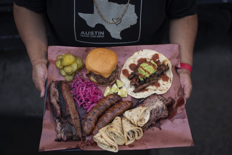 A selection of beef dishes are presented on a tray at Valentina's Tex Mex BBQ in Austin, Texas, Saturday, April 22, 2023. Later in the year, the restaurant re-opened in Buda, a suburb south of the capital. Beef was at the heart of Texas long before there was a Texas. As early as the 1600s, ranchers were raising thousands of cattle in the region, and as they expanded their herds and drew more settlers to the area, they built the foundation of what would become an independent country and then the 28th U.S. state. (AP Photo/David Goldman)