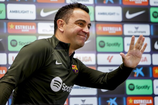 Barcelona's head coach Xavi Hernandez gestures during a press conference in Barcelona, Spain, Saturday, May 25, 2024. Barcelona says coach Xavi Hernandez is leaving the club at the end of the season. The club made the announcement on Friday after a meeting between club president Joan Laporta, Xavi and other senior figures at the team training ground. (AP Photo/Joan Monfort)