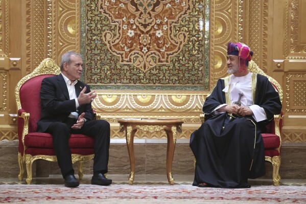 In this photo released by the Iranian Presidency Office, President Masoud Pezeshkian, left, speaks with Oman's Sultan Haitham bin Tariq Al Said during their meeting in Muscat, Oman, Tuesday, May 27, 2025. (Iranian Presidency Office via AP)