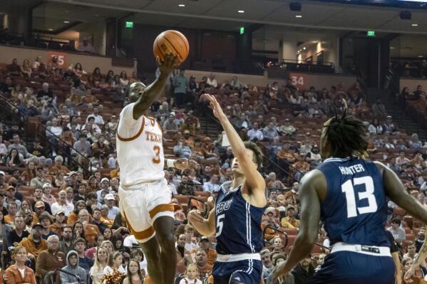 Texas guard Courtney Ramey (3) lays the ball up against California Baptist guard Reed Nottage (5) during the first half of an NCAA college basketball game, Wednesday, Nov. 24, 2021, in Austin, Texas. (AP Photo/Michael Thomas)