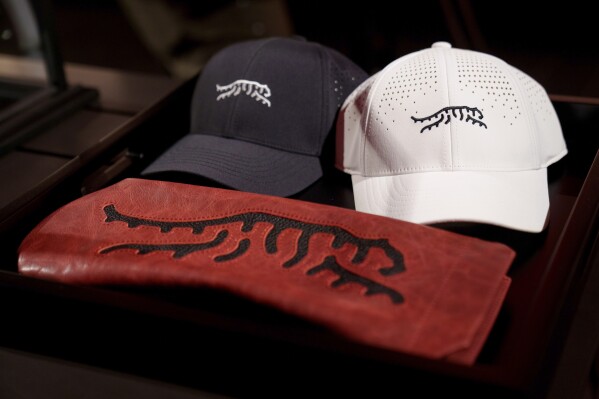 Merchandise from Tiger Woods' new clothing line, called Sun Day Red, is displayed during a news conference ahead of the Genesis Open golf tournament, Monday, Feb. 12, 2024, in the Pacific Palisades area of Los Angeles. (AP Photo/Eric Thayer)