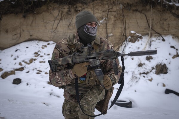A member of the pro-Ukrainian Russian ethnic Siberian battalion exercises at a military training ground near Kiev, Ukraine, Wednesday, Dec. 13, 2023.  The Ukrainian military has created a battalion of soldiers composed entirely of Russian citizens who want to fight against the Russian invasion.  (AP Photo/Efrem Lukatsky)