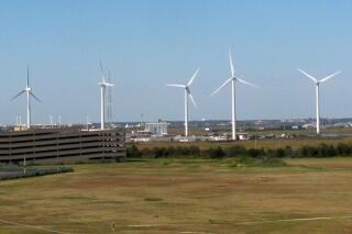 This Oct. 1, 2020 photo shows wind turbines at the Atlantic County Utilities Authority plant in Atlantic City, N.J. On Tuesday, June 15, 2021, New Jersey lawmakers advanced a proposed law that would fast track offshore wind energy projects by pre-empting local controls over power lines and other onshore infrastructure associated with them. (AP Photo/Wayne Parry)