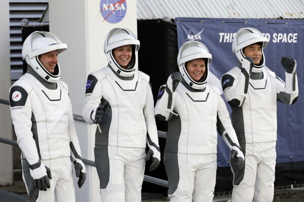 Crew10 members, from left, cosmonaut Kirill Peskov, astronaut Nichole Ayers, astronaut Anne McClain and JAXA astronaut Takuya Onishi leave the Operations and Checkout building before heading to Launch Pad 39-A at the Kennedy Space Center in Cape Canaveral, Fla., for a mission to the International Space Station in Cape Canaveral, Fla., Friday, March 14, 2025. (AP Photo/Terry Renna)