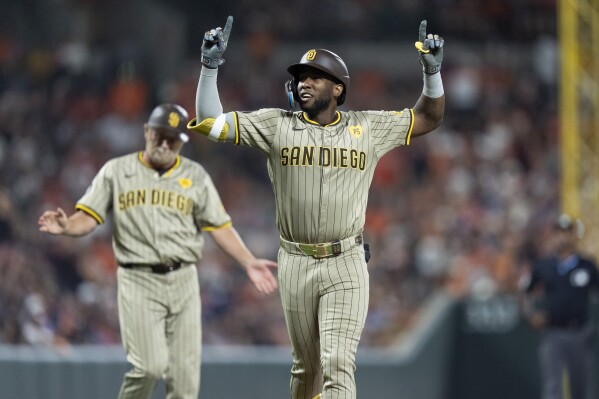 San Diego Padres' Jurickson Profar, right, celebrates after hitting a home run during the ninth inning of a baseball game against the Baltimore Orioles, Friday, July 26, 2024, in Baltimore. (ĢӰԺ Photo/Stephanie Scarbrough)