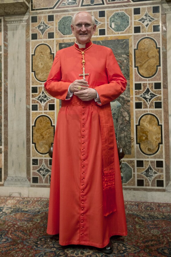 Newly-elected Cardinal James Michael Harvey from the U.S. poses for photographers prior to meeting relatives and friends after he was elevated to cardinal by Pope Benedict XVI, at the Vatican during a consistory, Nov. 24, 2012. (AP Photo/Andrew Medichini, File)
