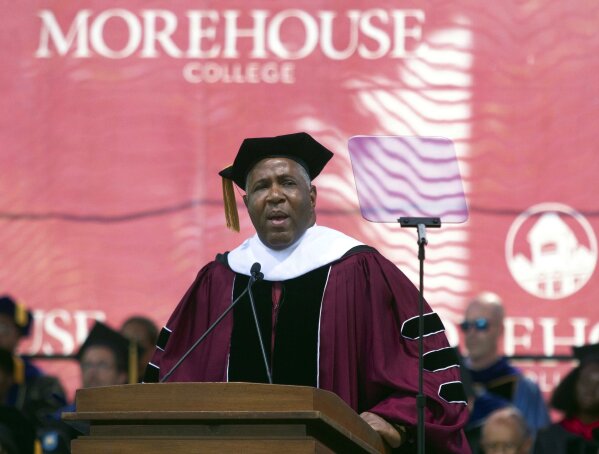 FILE - In this May 19, 2019, file photo, billionaire technology investor and philanthropist Robert F. Smith announces he will provide grants to wipe out the student debt of the entire 2019 graduating class at Morehouse College in Atlanta. DOJ charges Houston billionaire Robert Brockman, not seen, with $2 billion tax fraud in largest such fraud case against an American. Prosecutors also announced Thursday, Oct. 15, 2020, that Robert Smith, founder and chairman of investment firm Vista Equity Partners, will cooperate in the investigation and pay $139 million to settle a tax probe. (Steve Schaefer/Atlanta Journal-Constitution via AP, File)