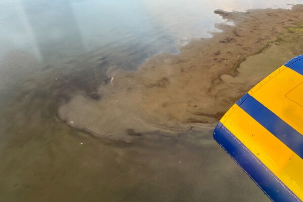 FILE - This photo provided by North Slope Borough shows an aerial view of a shallow lake where a helicopter crashed on Alaska's North Slope near Utqiagvik, Alaska, Thursday, July 20, 2023. Alaska search and rescue divers recovered the bodies of a helicopter pilot and three state scientists, Sunday, July 23, from the sunken wreckage of their aircraft, which went down several days earlier in a shallow lake on the remote North Slope, authorities said. (North Slope Borough via AP, File)