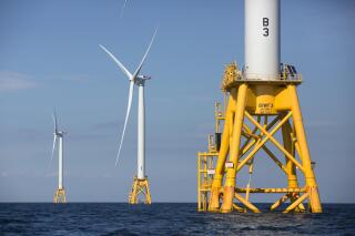 FILE - In this Aug. 15, 2016 file photo, three wind turbines stand in the water off Block Island, R.I, the nation's first offshore wind farm. The Biden administration wants to know whether offshore wind companies want to move into the Gulf of Mexico. The Interior Department said Tuesday, June 8, 2021 that an agency overseeing offshore leases will seek requests for interest from companies. (AP Photo/Michael Dwyer, File)